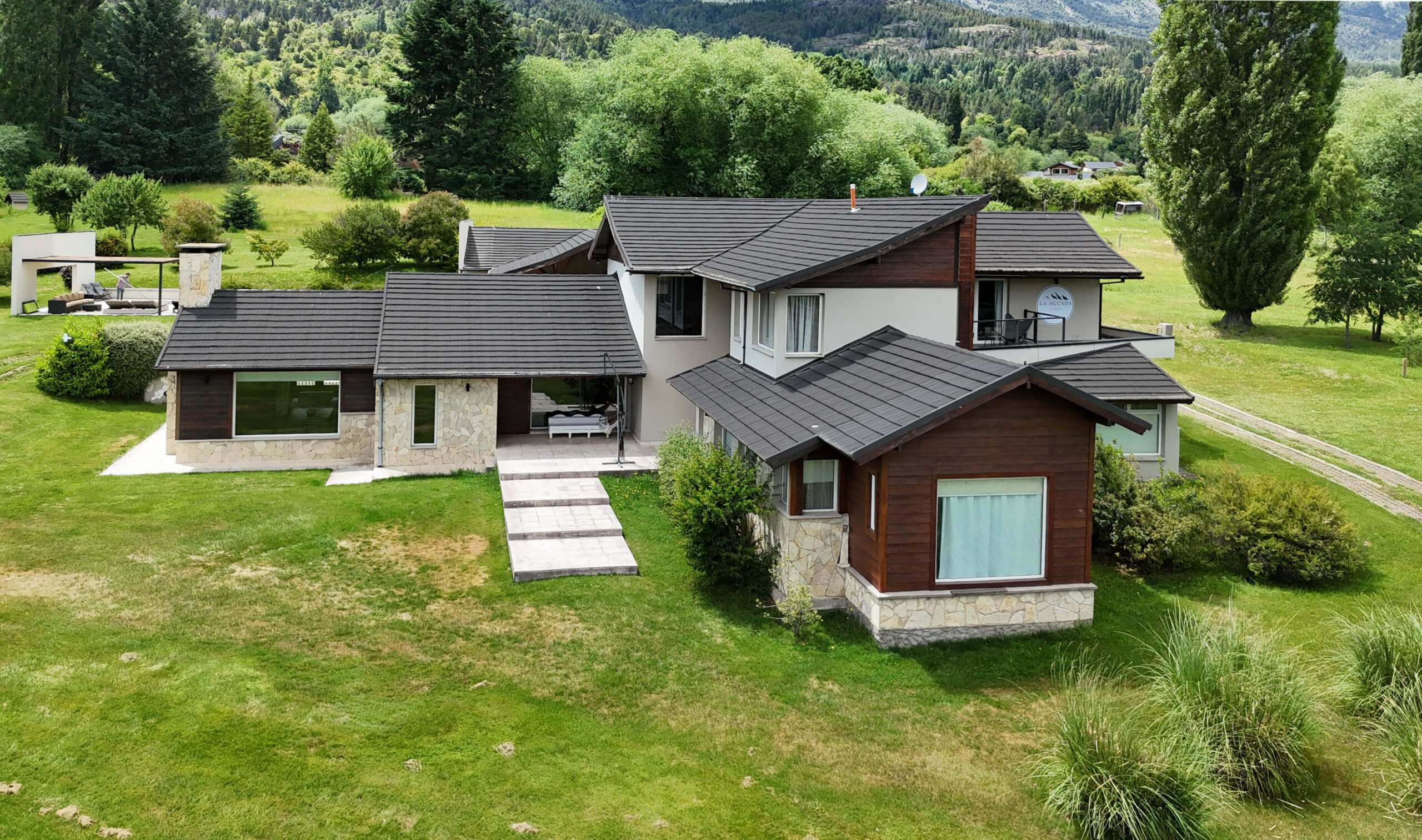 Vista aérea de La Aguada Suite | El Bolsón Patagonia Vista aérea de La Aguada Suite en El Bolsón, con parque amplio y entorno de montaña en Patagonia