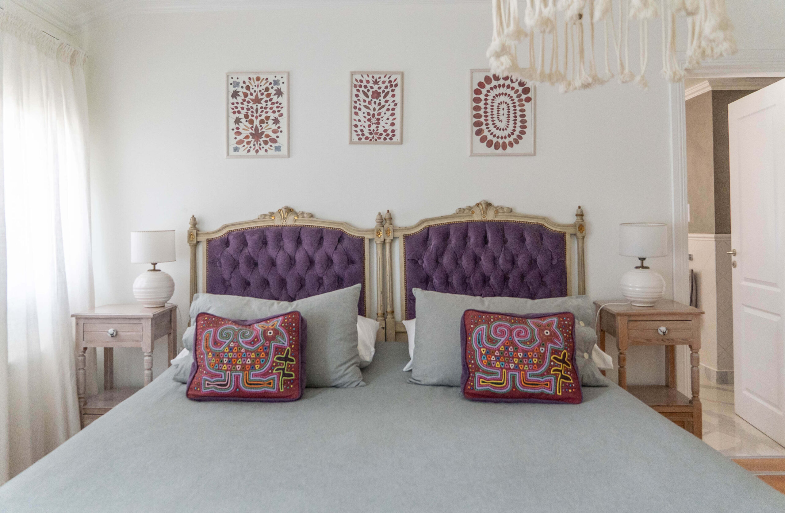 Dormitorio de la Habitación Clásica 1 en La Aguada Suite, El Bolsón, con cama amplia y cabeceros capitoné violetas